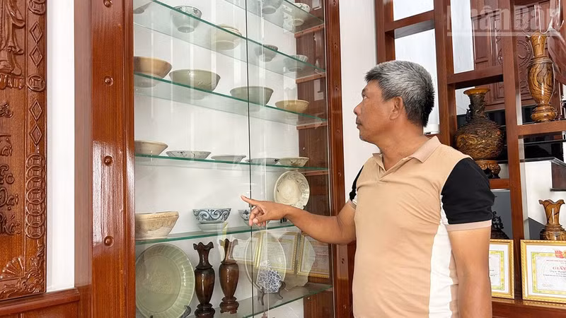 Fisherman Nguyen Thuan with his collection of recovered artefacts.