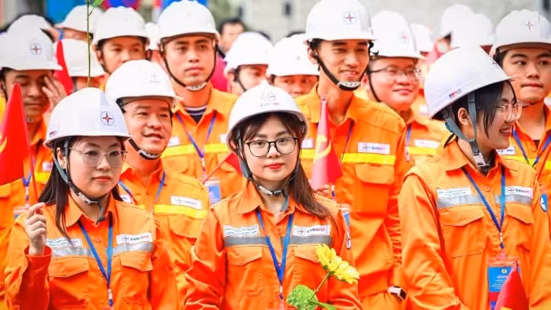 Workers parade to celebrate the 140th anniversary of International Labour Day.