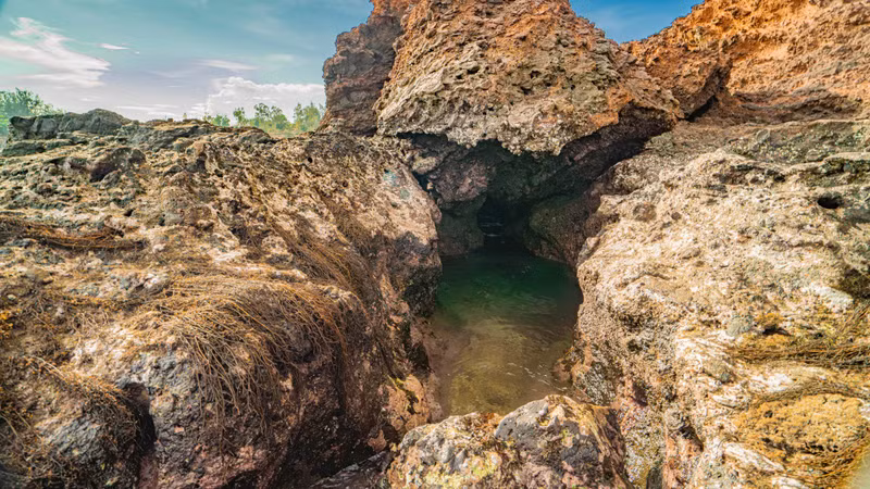 The retreating tide also reveals caves beneath the layers of ancient volcanic rock.