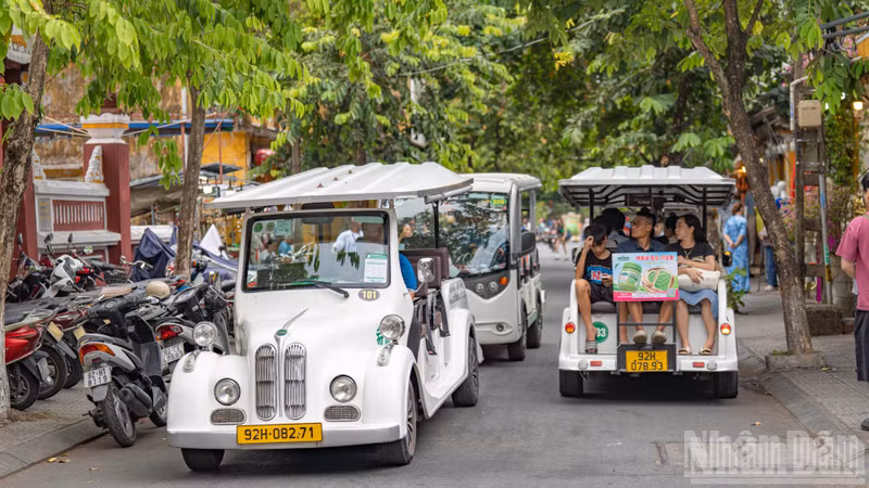 Electric shuttle buses operate at full capacity, ferrying visitors from car parks to the heart of Hoi An Ancient Town.