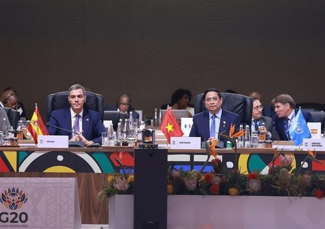 Prime Minister Pham Minh Chinh (R) speaks at the G20 Summit’s third session. (Photo: VNA)