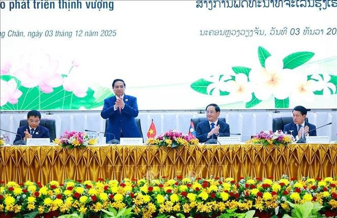 PM Pham Minh Chinh attends the Viet Nam - Laos investment promotion conference (Photo: VNA)