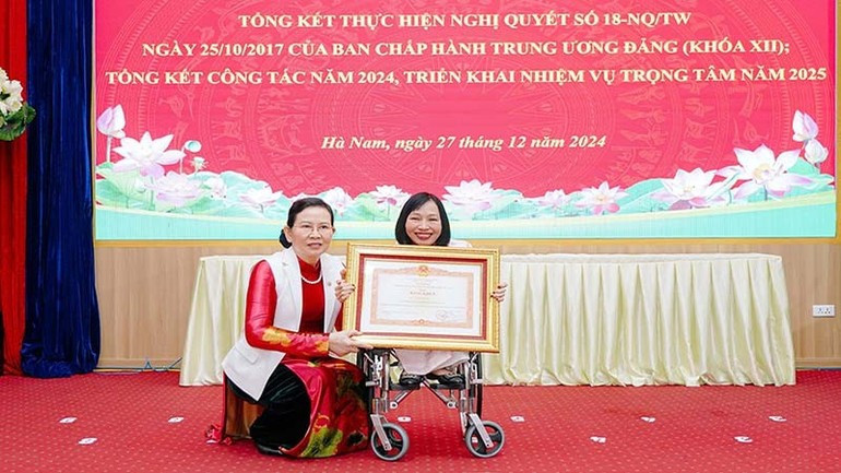 Le Thi Thuy, former Secretary of the Ha Nam Party Committee, presents Nga with a Certificate of Merit from the Prime Minister. 277777.jpg