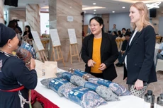 Guests visit an exhibition showcasing products from communities participating in the project.