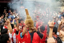 People cheer when a team make fire successfully, in preparation for cooking rice. 