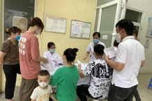 People register for COVID-19 vaccination at a health station in Hanoi. (Photo: VNA)