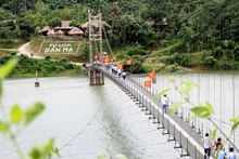 Visitors to Ma Village community-based tourism site in Thuong Xuan District, Thanh Hoa Province. 