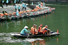 Foreign tourists visit Trang An scenic landscape in Ninh Binh Province. 