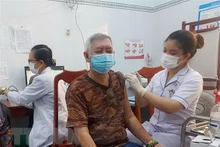 A man gets vaccinated against COVID-19. (Photo: VNA)