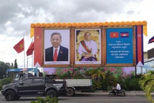 Portraits of Vietnamese Party General Secretary To Lam (L) and King Preah Bat Samdech Preah Boromneath Norodom Sihamoni on a street in Phnom Penh. (Photo by NGUYEN HIEP)