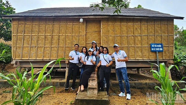 Visitors take photos with the restored stilt house in the revolutionary village of Stor. langstor-121025-2.jpg