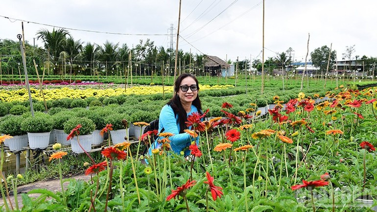 Visitors pose beside Sa Dec’s flower gardens.