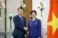Prime Minister Le Minh Hung (L) receives President of the Asian Infrastructure Investment Bank (AIIB) Zou Jiayi on the sidelines of the 18th BRICS Summit in New Delhi, India, on September 12. (Photo: VNA)