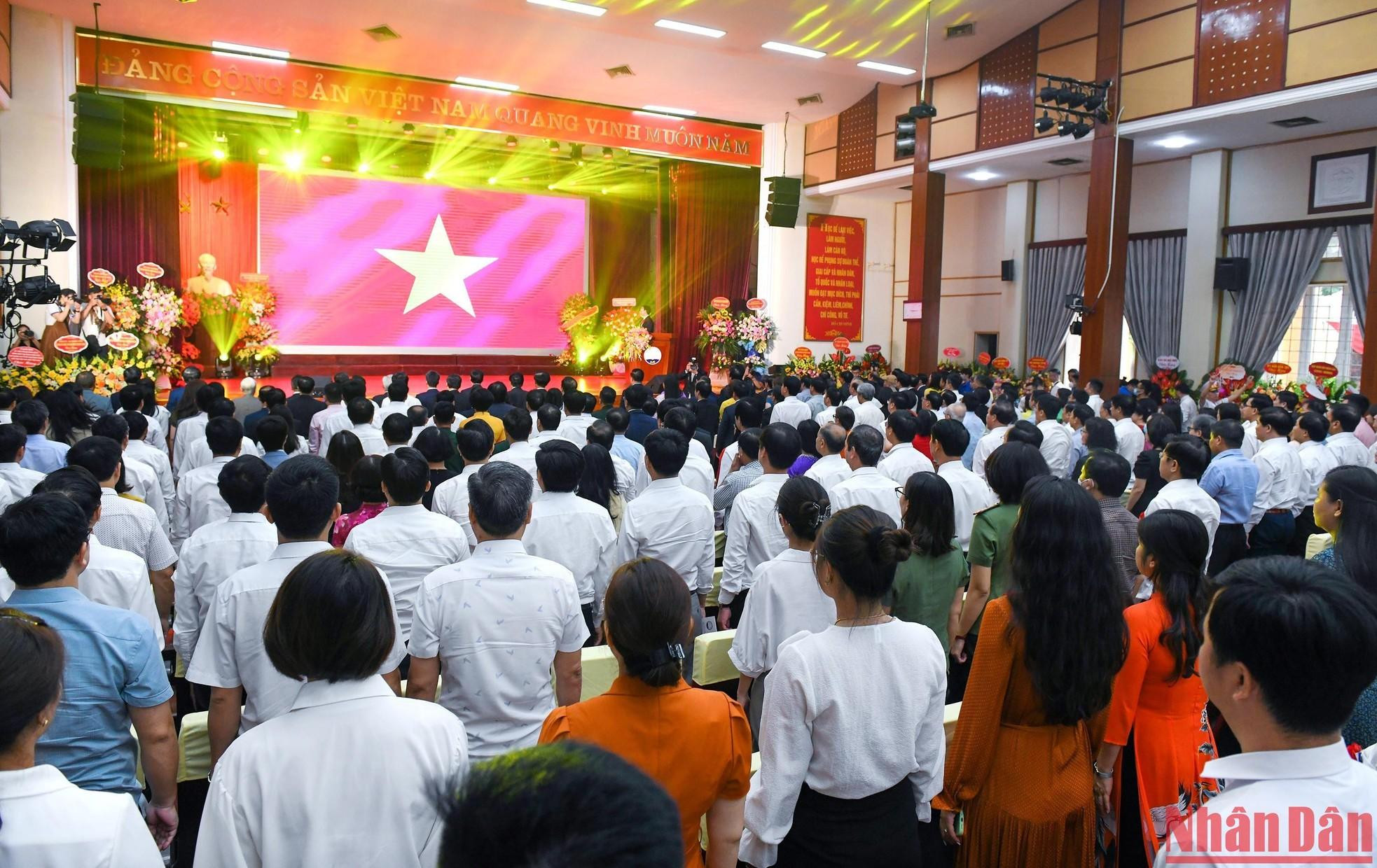 The delegates perform the flag-raising ceremony.