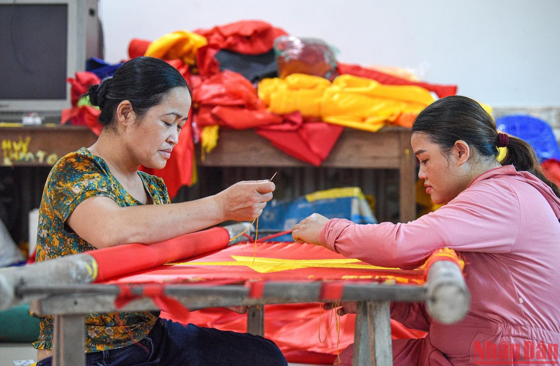 Vuong Thi Nhung says the craft of making the five-pointed golden star flag has been with her family for over seven decades. Vuong Thi Nhung says the craft of making the five-pointed golden star flag has been with her family for over seven decades.