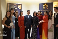 Director of the Viet Nam Cultural Centre in France, Dinh Ngoc Duc (fifth from the left), poses for a group photo with members of the organising committee of the "Cinema Night - Bridge of Light". (Photo: VNA)