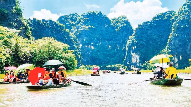 Visitors tour Tam Coc tourism site in Ninh Binh.