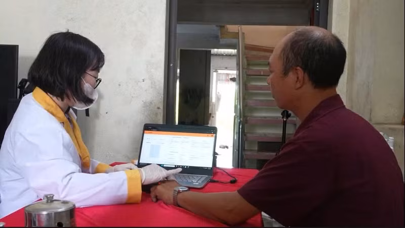 The younger brother of fallen soldier Nguyen Van Nhuan has a DNA sample taken for matching.