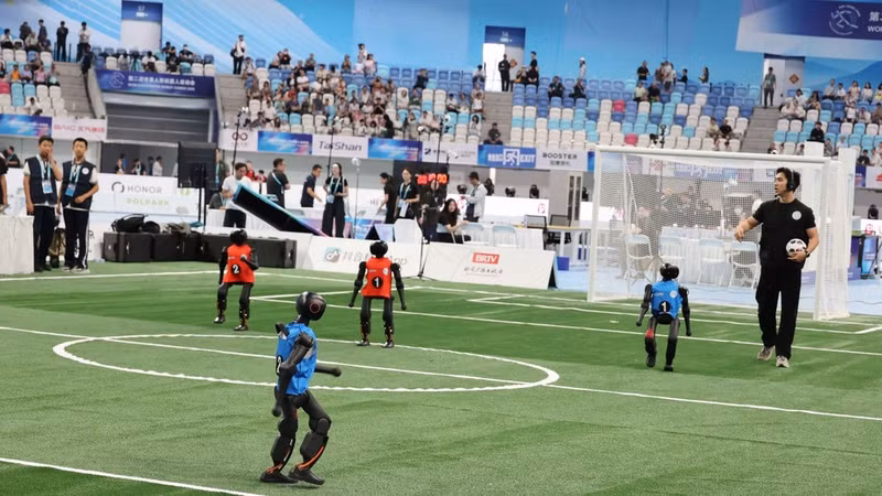 Humanoid robots from competing teams take part in the football event. (Photo: VNA)