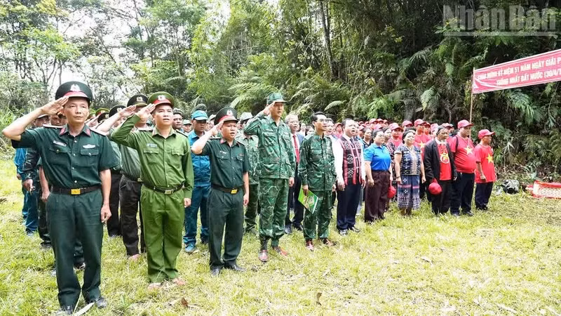 Local leaders, officials, armed forces, village elders, respected community figures and Party cell secretaries perform the flag salute ceremony at Border Marker 678.