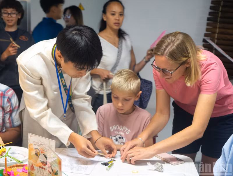 Charlotte and her son take part in a traditional Vietnamese handicraft activity.