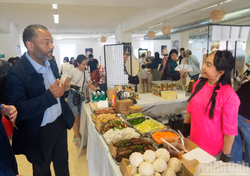 .Liem speaks in Vietnamese with visitors and the Vietnamese community about Vietnamese culture and cuisine at the festival.