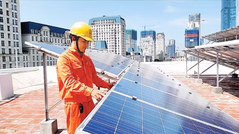 Electricity workers in Ho Chi Minh City install a rooftop solar power system.