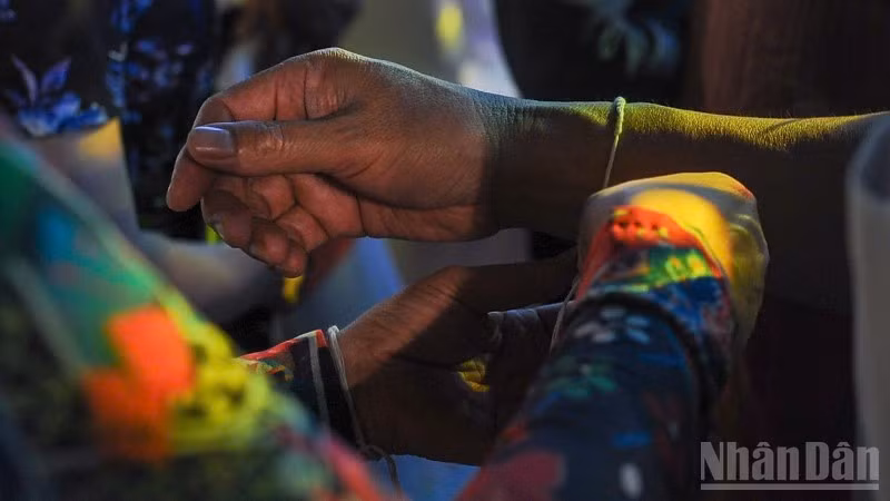 The wrist-tying ritual to offer blessings and prayers for peace.
