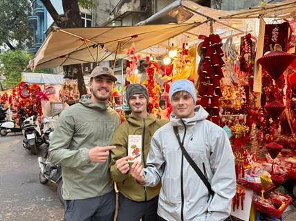 Young visitors from Wales visit Tet market booths during their trip.
