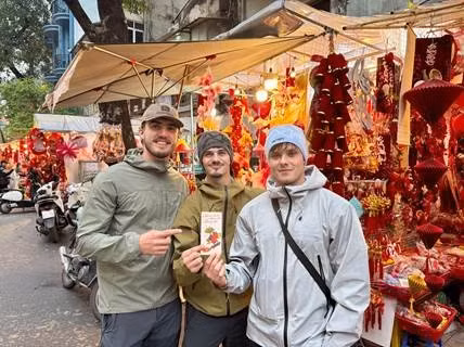 Young visitors from Wales visit Tet market booths during their trip.