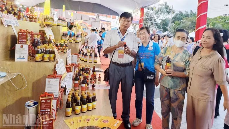 Delegates visit an exhibition booth showcasing Phu Quoc fish sauce products at the 2025 Phu Quoc Fish Sauce Festival.
