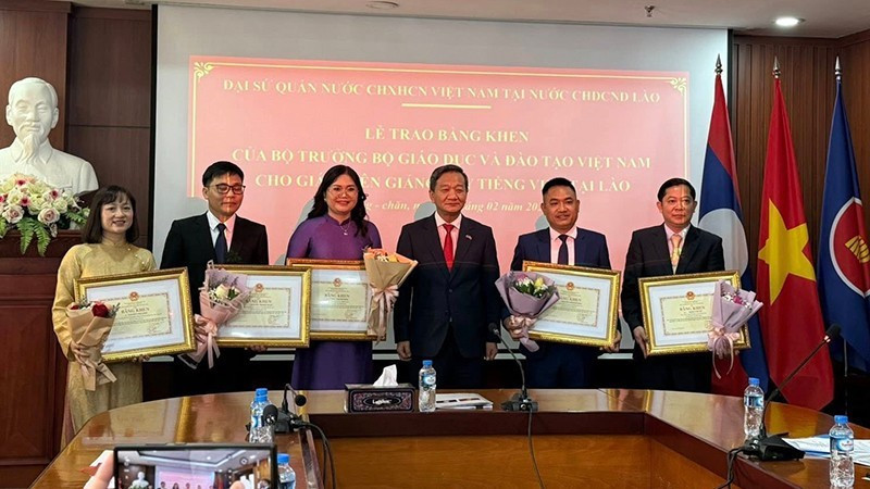Ambassador Nguyen Minh Tam presents Certificates of Merit to five Vietnamese-language teachers in Laos. (Photo: DUY TOAN)
