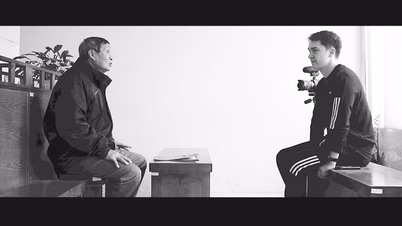 Bibonne (right) during a filmed interview with coach Mai Duc Chung.