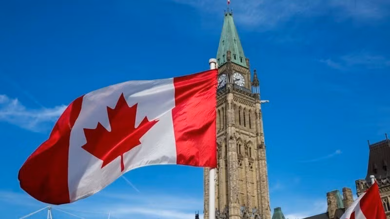 The Canadian flag flies over Parliament Hill in Ottawa. (Photo: Government of Canada)