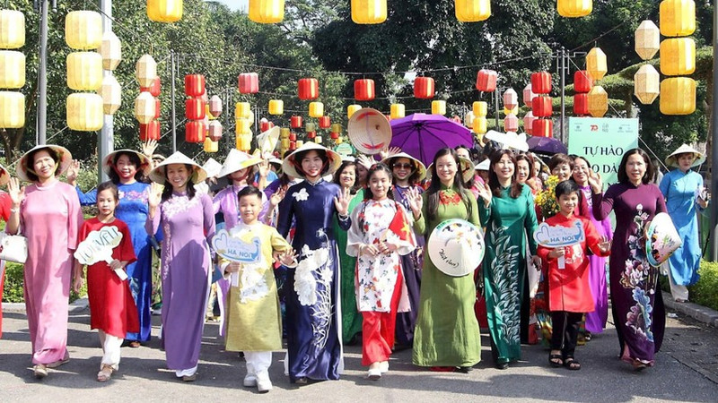 Residents of Ha Noi and visitors take part in an ao dai parade event.