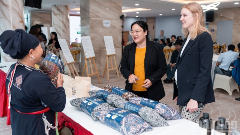 Guests visit an exhibition showcasing products from communities participating in the project.