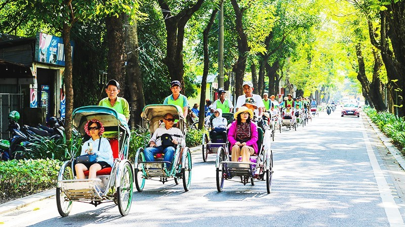 Visitors explore Hue’s green tourism by cyclo.