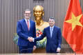 PM Le Minh Hung (R) and French Ambassador Olivier Brochet. (Photo: nhandan.vn)