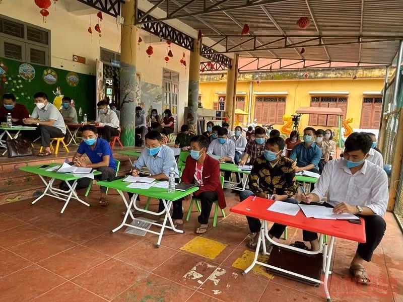 Party members attend a model Party cell meeting in Huoi Hau Village.