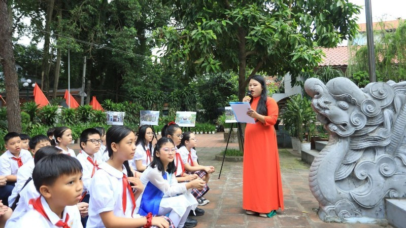 Pupils at Xuan La Primary School (Ha Noi) study local history at the Quan La Communal House, a heritage site. (Photo: GIANG NAM)