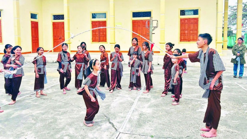 Children from the “Anchoring the soul of Vi and Giam” class during a roots-return activity, taking part in traditional folk games.