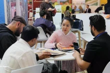 A representative of a Vietnamese enterprise shows it products at ITB Berlin 2026. (Photo: VNA)