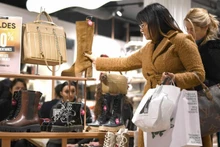 People shop at a store in Geneva, Switzerland. (Photo: Xinhua)