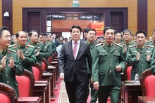State President Luong Cuong (in black suite) attends the national political-military conference in Ha Noi on December 17. (Photo: VNA)