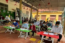 Party members attend a model Party cell meeting in Huoi Hau Village.