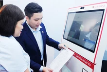 Citizens access the system for copying and providing authenticated electronic documents at a public administrative centre. Photo: NAM ANH