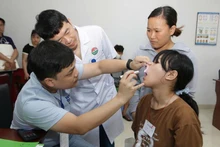 Medical staff from Viet Nam–Cuba Friendship Hospital conduct screening examinations for children as part of the programme.
