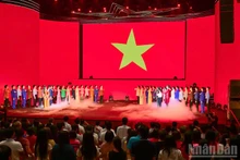 Artists and guests attending the programme during the flag-raising ceremony. (Photo: BAO LONG)