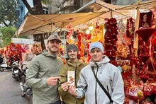 Young visitors from Wales visit Tet market booths during their trip.