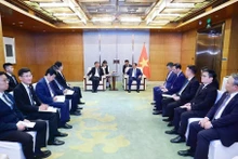Prime Minister Pham Minh Chinh (right) works with Vice Chairman of COMAC Shen Bo. (Photo: VNA)